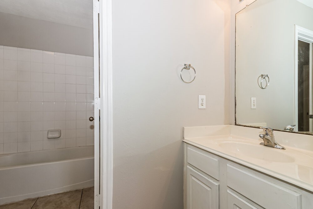 16419 Great Ridge Court Houston, TX 77083 - Photo 15 of 16 a bathroom with a sink and a mirror
