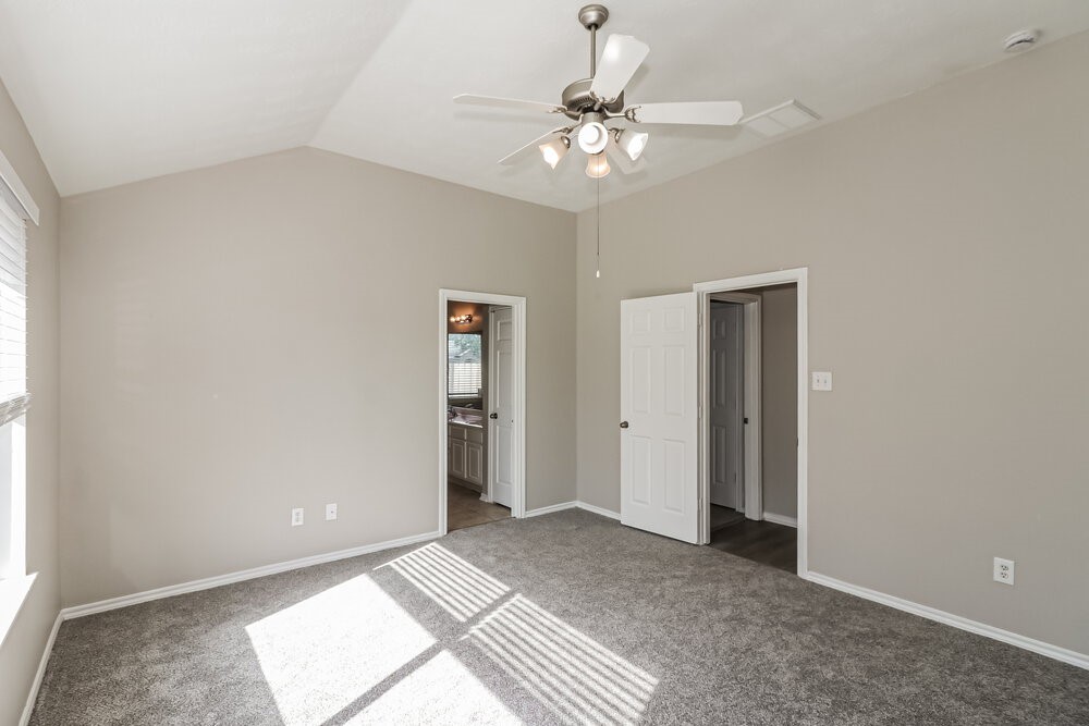 16419 Great Ridge Court Houston, TX 77083 - Photo 9 of 16 a view of an empty room with a chandelier fan