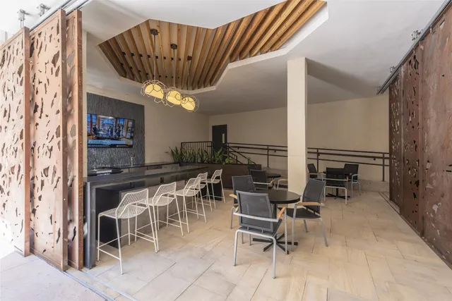 a dining room with furniture and a chandelier