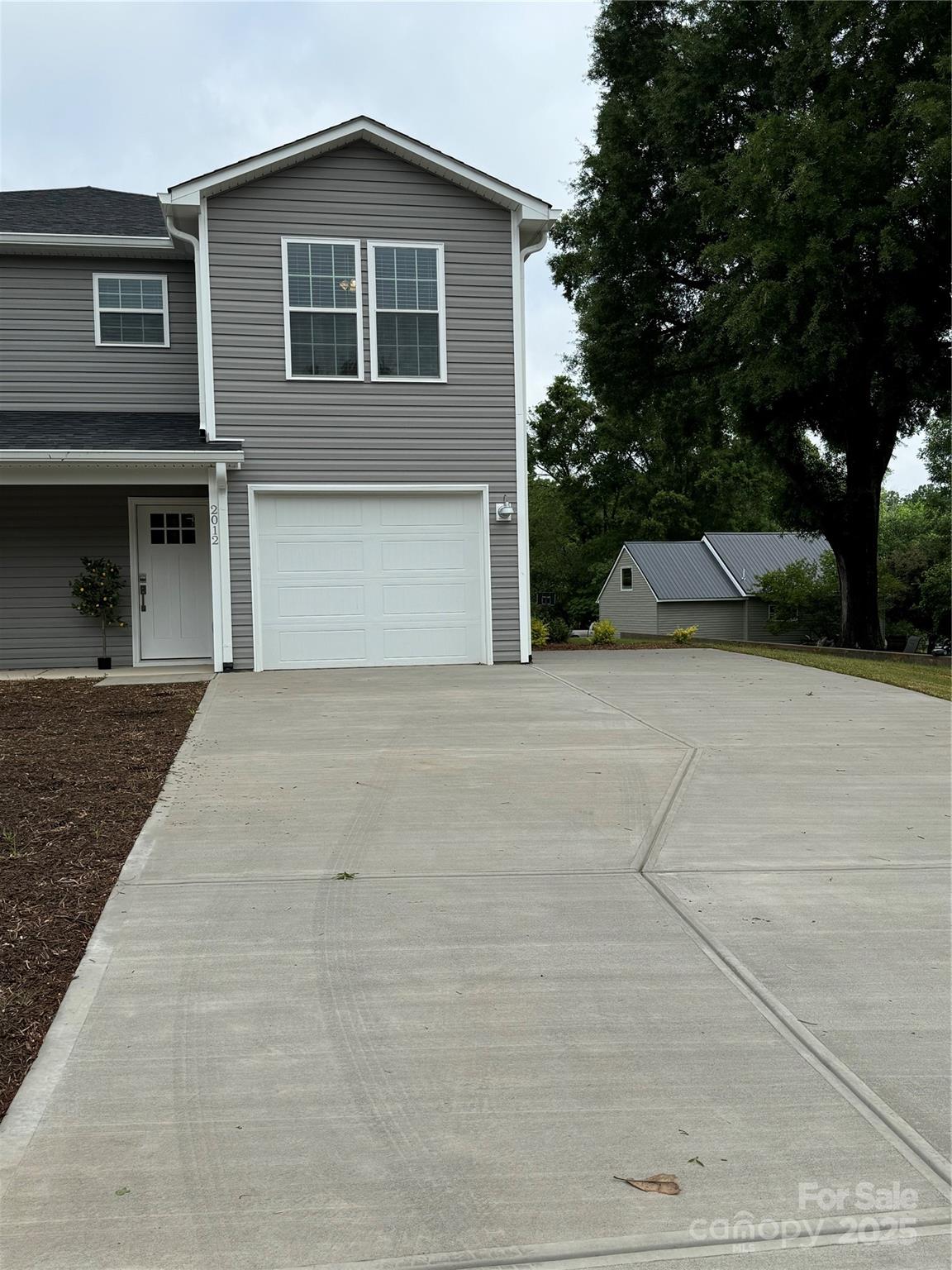 2012 Crown Point Drive Albemarle, NC 28001 - Photo 2 of 41 a view of a house with a yard and garage