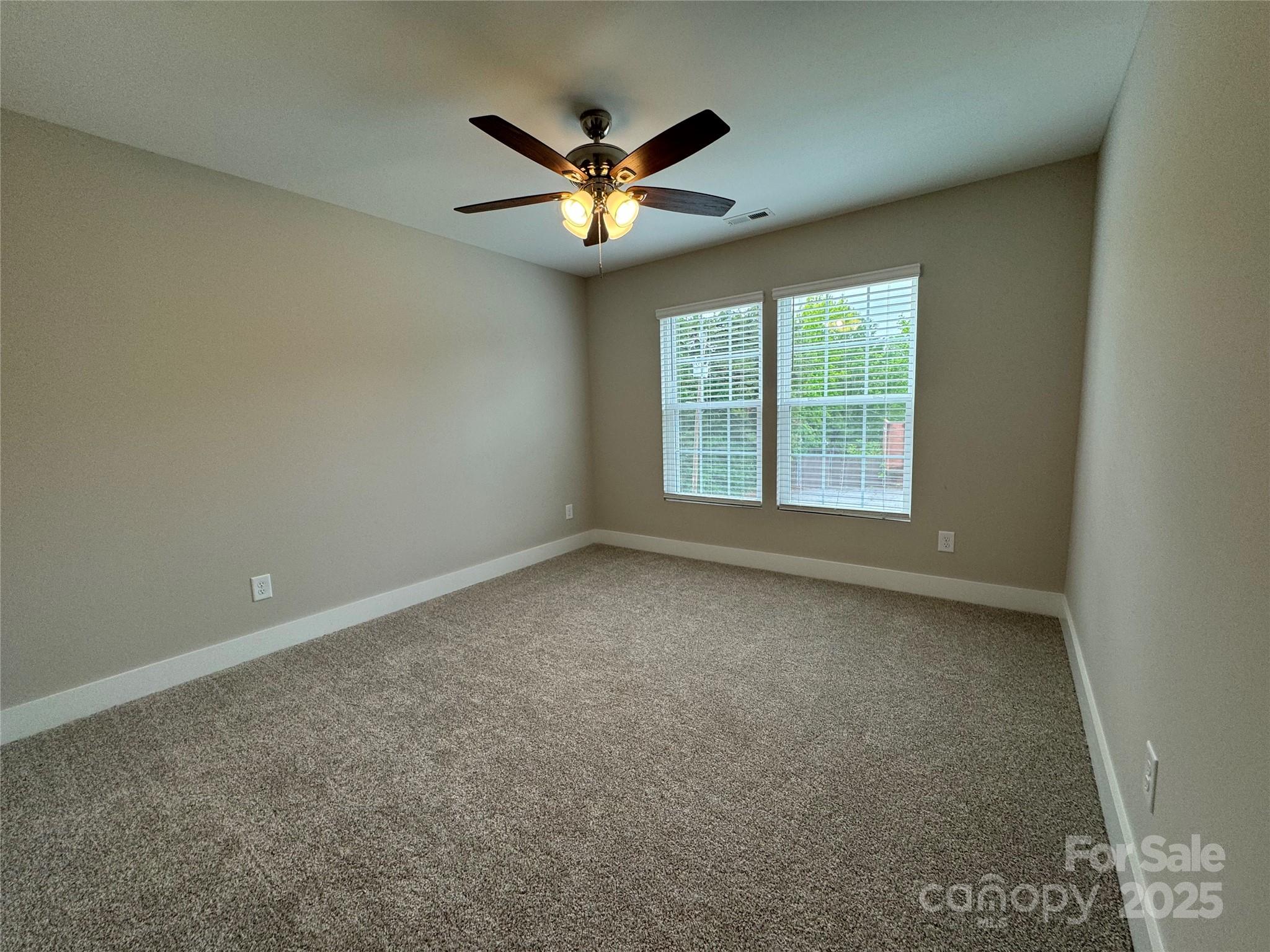 2012 Crown Point Drive Albemarle, NC 28001 - Photo 29 of 41 an empty room with windows and ceiling fan