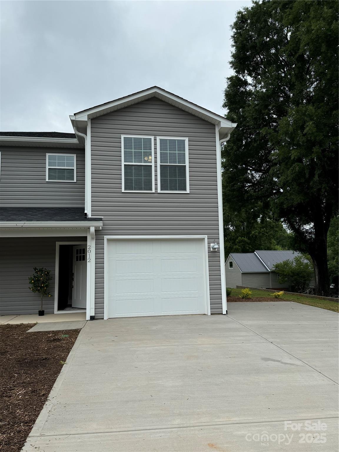 2012 Crown Point Drive Albemarle, NC 28001 - Photo 5 of 41 a front view of a house with a yard and garage