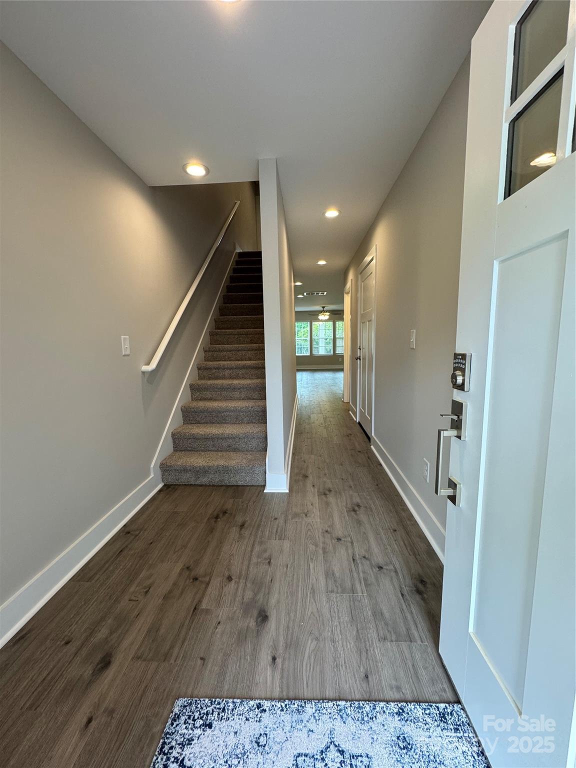2012 Crown Point Drive Albemarle, NC 28001 - Photo 7 of 41 a view of a hallway with wooden floor and stairs