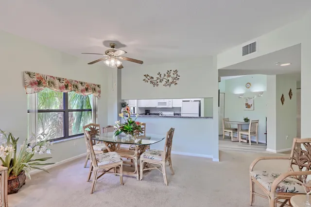 a view of a dining room with furniture and a chandelier