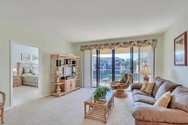 a living room with furniture and view of kitchen