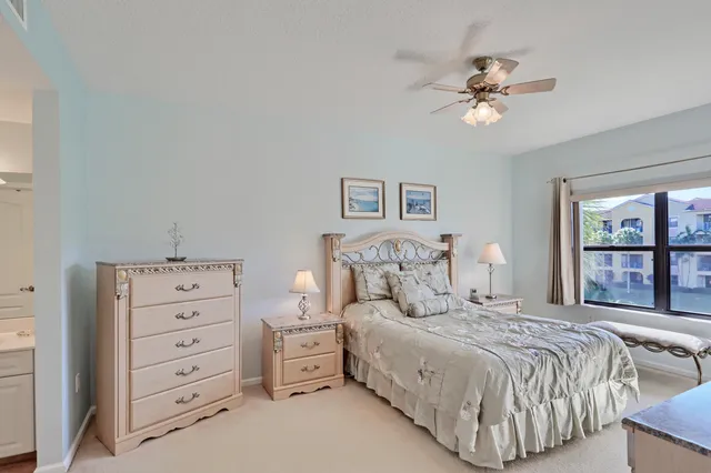 a spacious bedroom with a bed and a flat screen tv