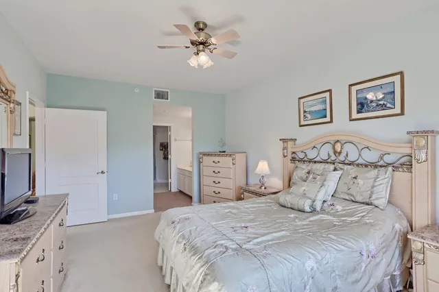 a en suite bathroom with double vanity a mirror two sinks and a bathtub
