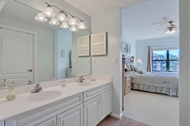 a bathroom with double vanity sinks and a mirror