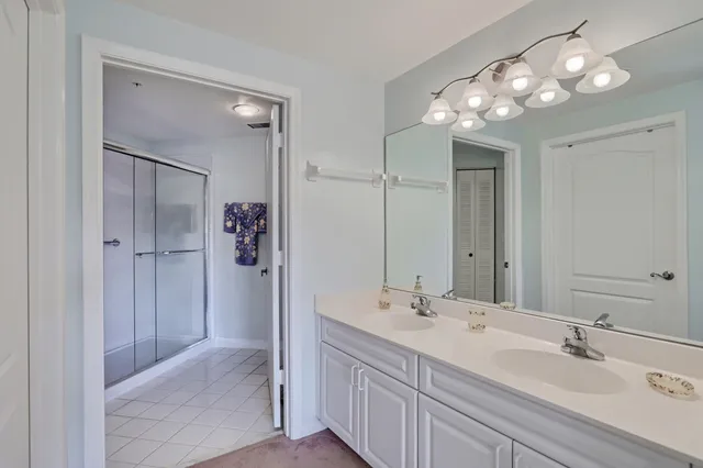 a bathroom with a shower and a glass door