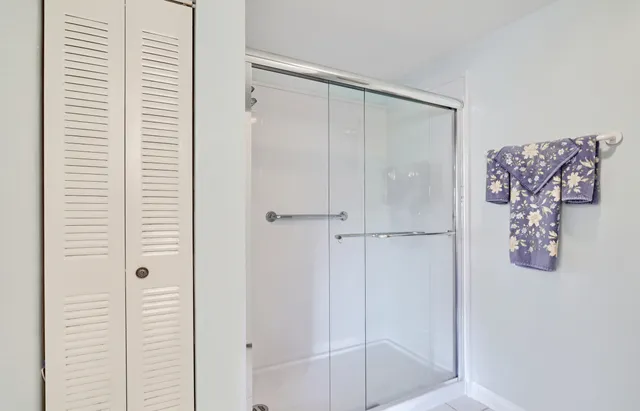 a bedroom with a bed chairs and a window