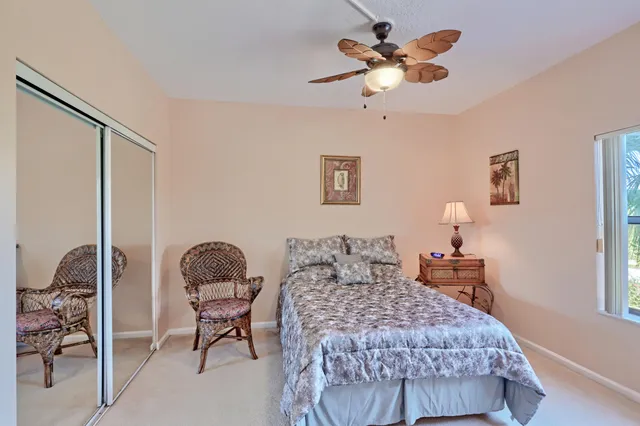 a view of a bedroom with furniture and window