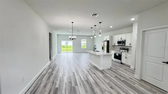 a view of kitchen with cabinets and stainless steel appliances