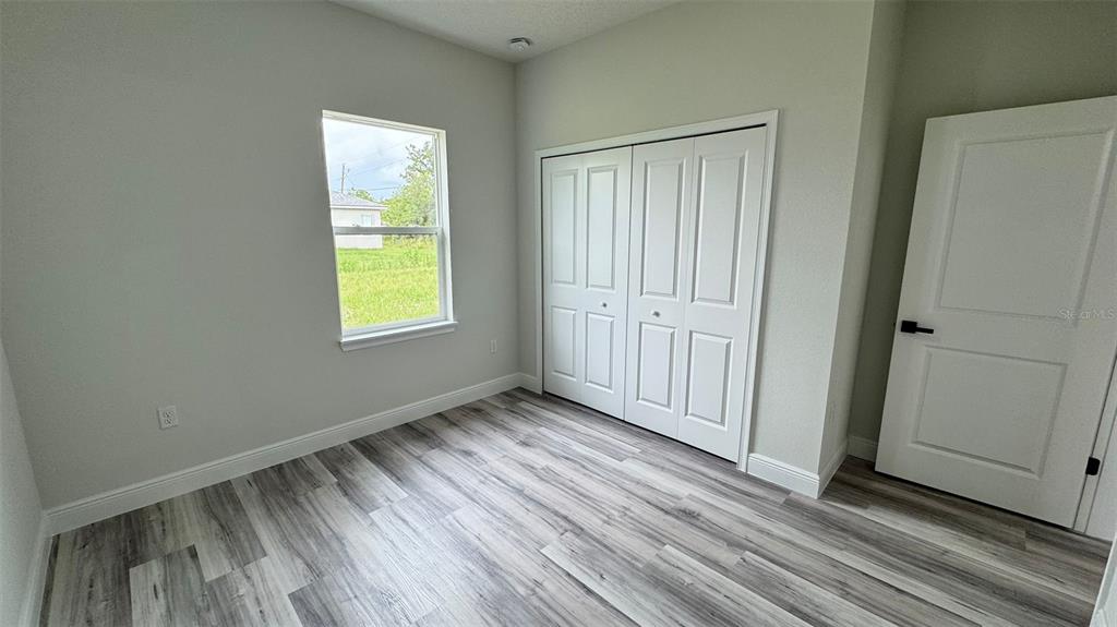 16884 Southwest 39th Circle Ocala, FL 34472 - Photo 15 of 29 an empty room with wooden floor and windows