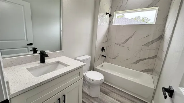 a bathroom with a sink a toilet and a bathtub