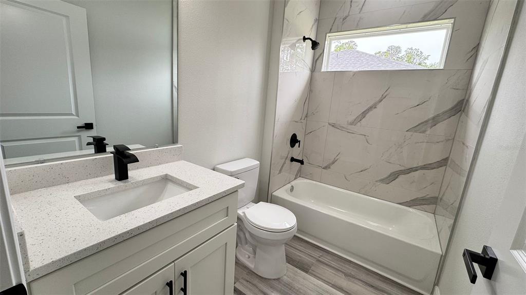 16884 Southwest 39th Circle Ocala, FL 34472 - Photo 18 of 29 a bathroom with a sink a toilet and a bathtub