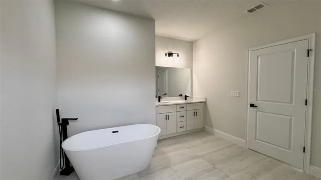 a spacious bathroom with a bathtub sink and toilet