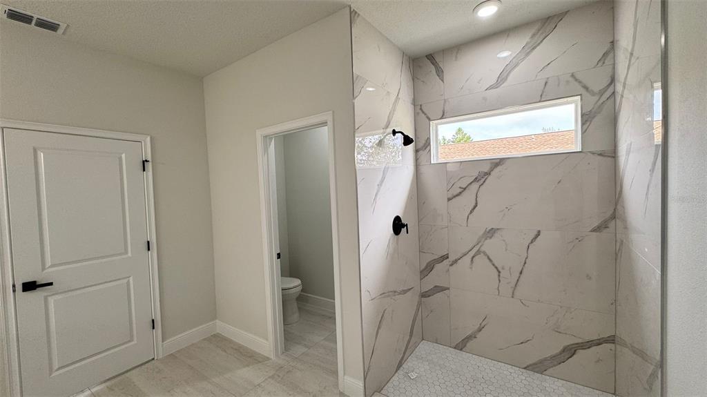 16884 Southwest 39th Circle Ocala, FL 34472 - Photo 22 of 29 a bathroom with a bathtub and a shower