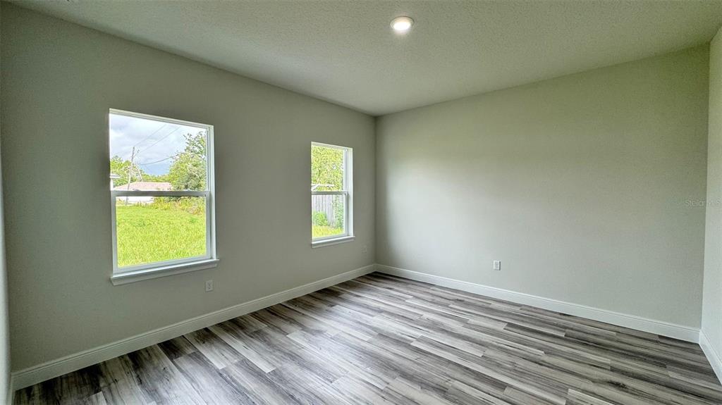 16884 Southwest 39th Circle Ocala, FL 34472 - Photo 25 of 29 a view of an empty room with wooden floor and a window
