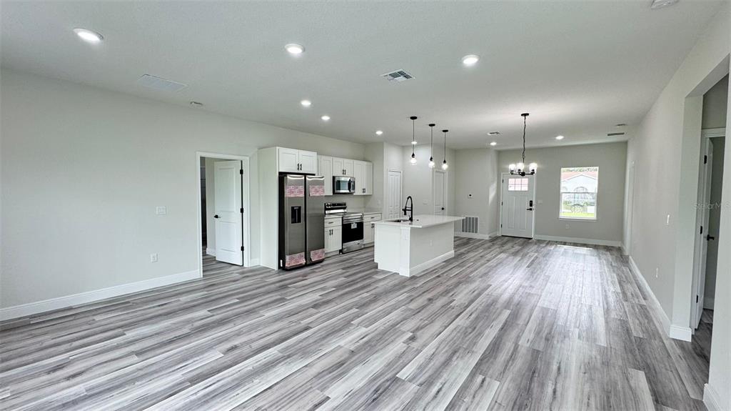 16884 Southwest 39th Circle Ocala, FL 34472 - Photo 6 of 29 a view of a kitchen with a sink and a refrigerator