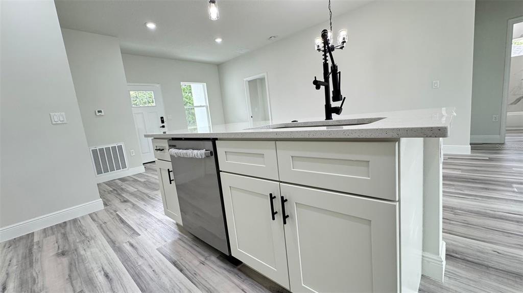 16884 Southwest 39th Circle Ocala, FL 34472 - Photo 9 of 29 a kitchen with a sink cabinets and wooden floor