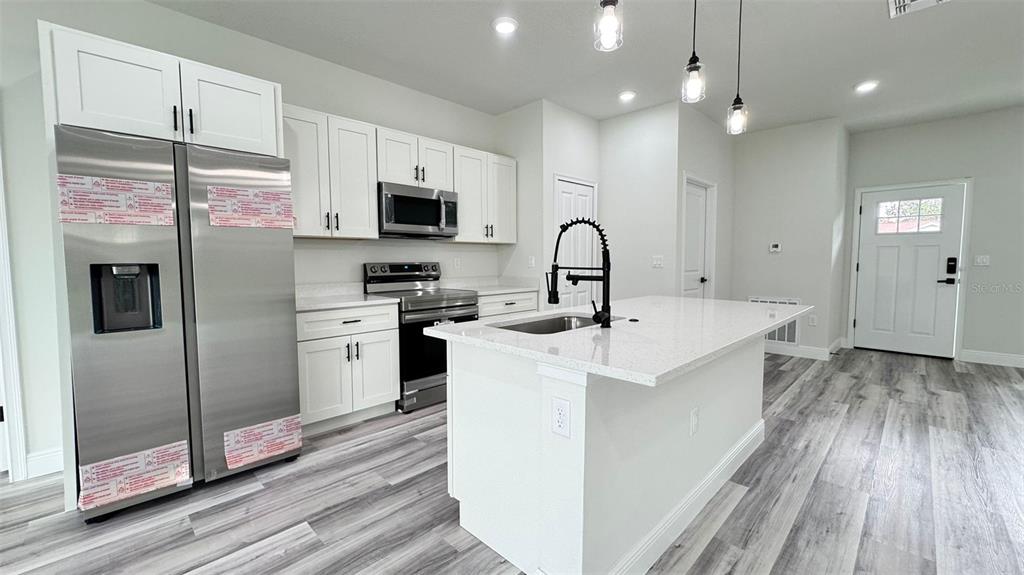16884 Southwest 39th Circle Ocala, FL 34472 - Photo 10 of 29 a kitchen with kitchen island a sink stainless steel appliances and counter space