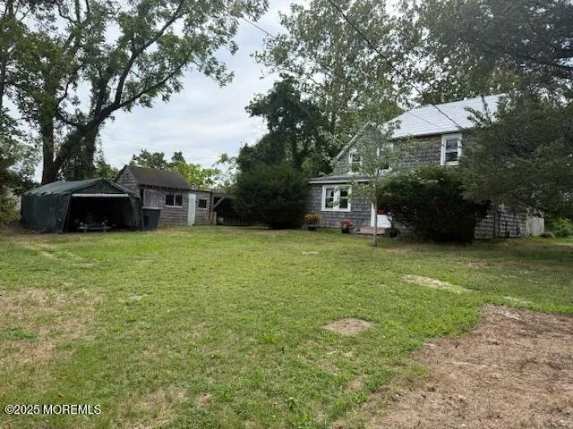 a view of a house with a yard porch and sitting area