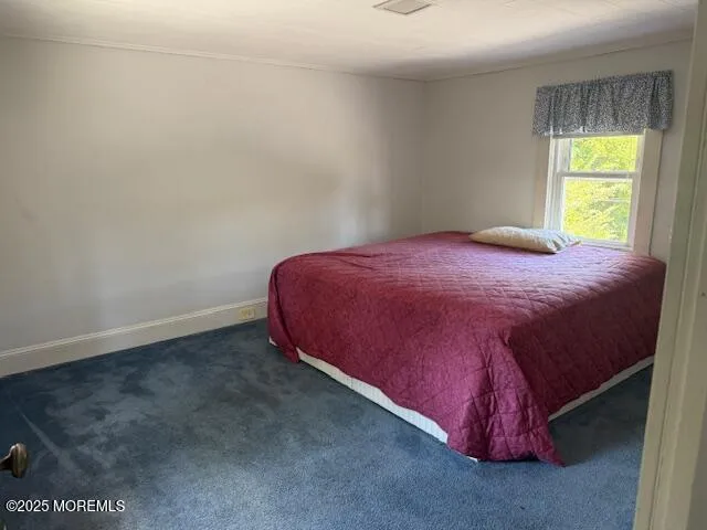 a bedroom with a bed and a window in it