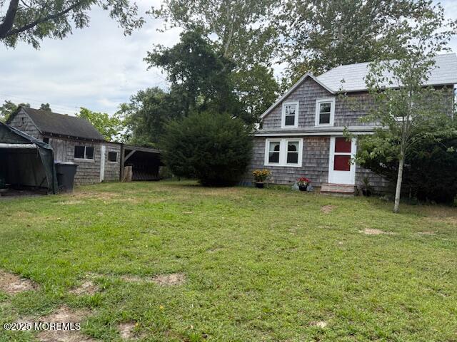 548 Hill Road Toms River, NJ 08753 - Photo 2 of 16 a front view of a house with a garden