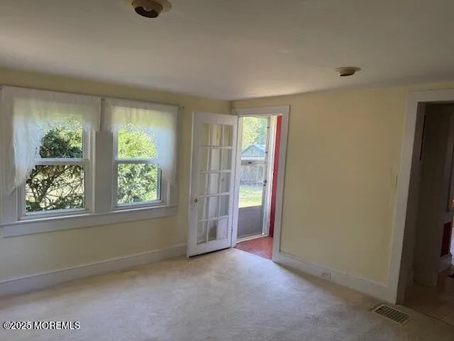 an empty room with windows and closet