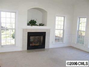 4516 Steepleton Way Charlotte, NC 28215 - Photo 2 of 3 an empty room with windows and fireplace