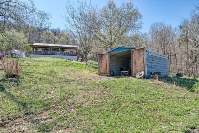 a view of a house with a yard and tree