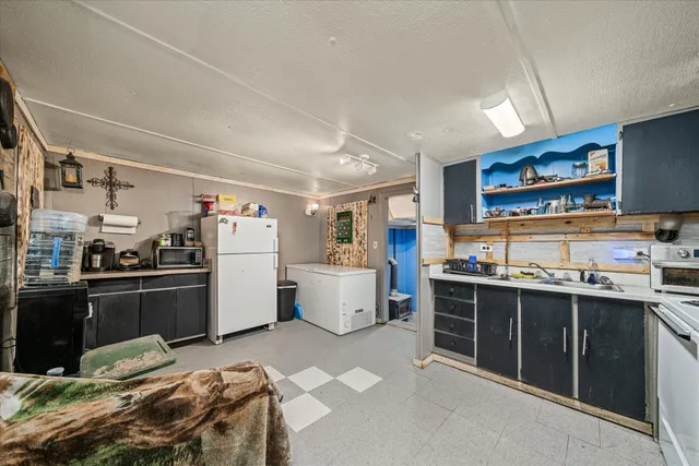 a kitchen with a stove sink and cabinets