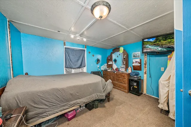 a bedroom with a bed and a mirror