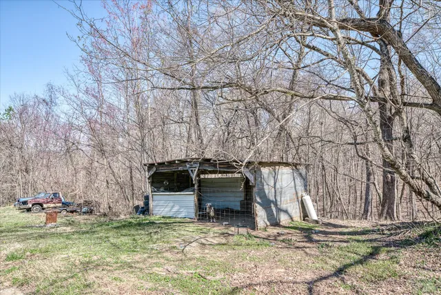 a backyard of a house with barbeque oven