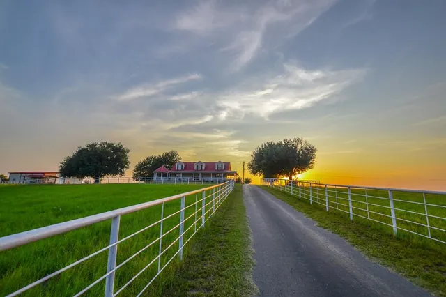 a living room with furniture a large window and a clock
