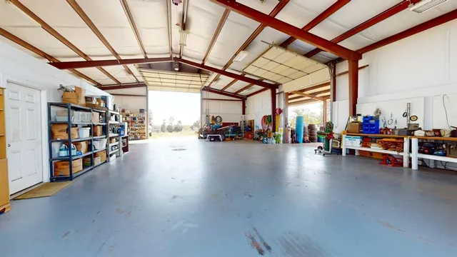 a spacious bathroom with a granite countertop sink a toilet a mirror and shower