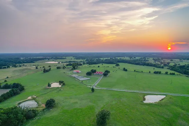 a view of a street with a big yard