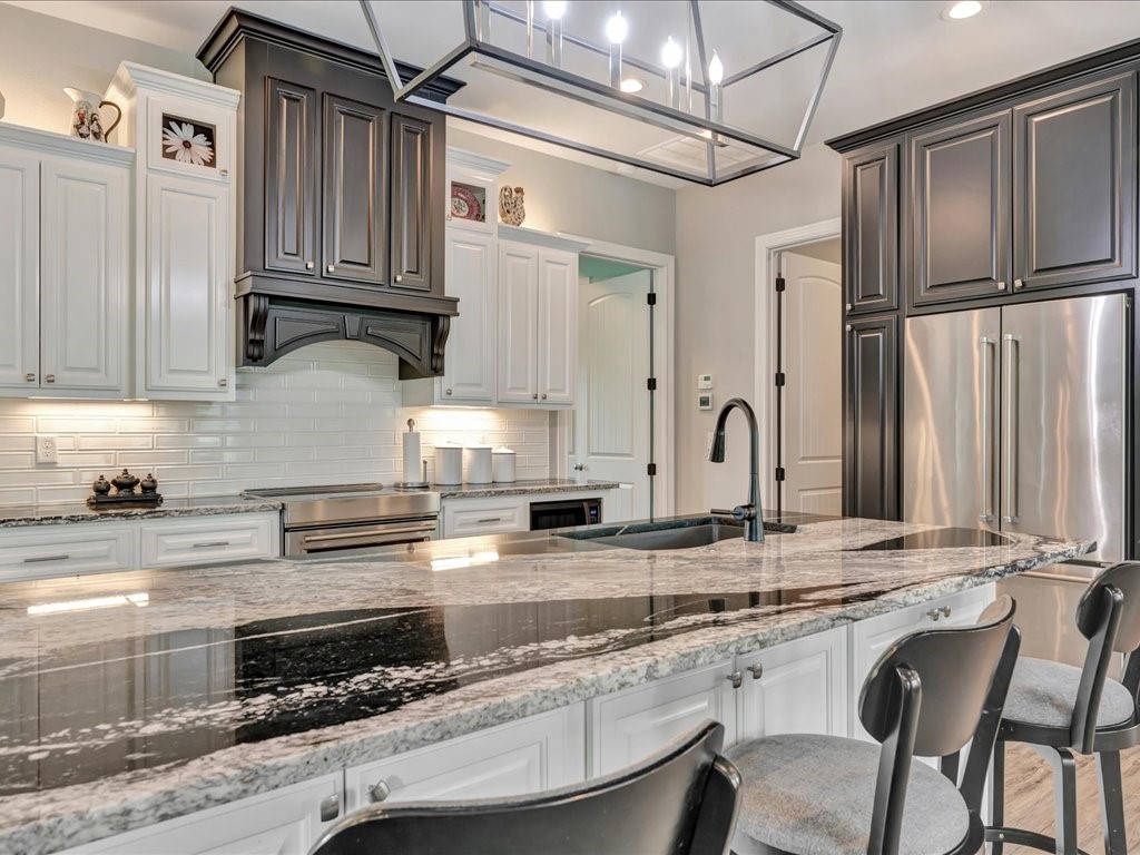 104 Wheeler Road Lufkin, TX 75901 - Photo 12 of 45 a kitchen with stainless steel appliances granite countertop a sink refrigerator and cabinets