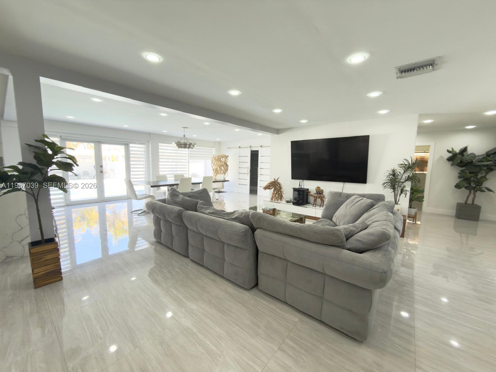 4801 West Park Road Hollywood, FL 33021 - Photo 12 of 30 a living room with furniture and a flat screen tv