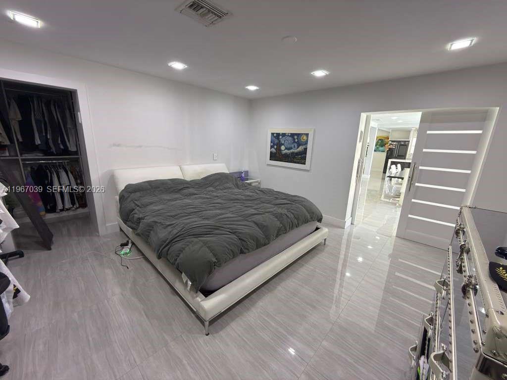 4801 West Park Road Hollywood, FL 33021 - Photo 13 of 30 a spacious bedroom with a bed and a walk in closet