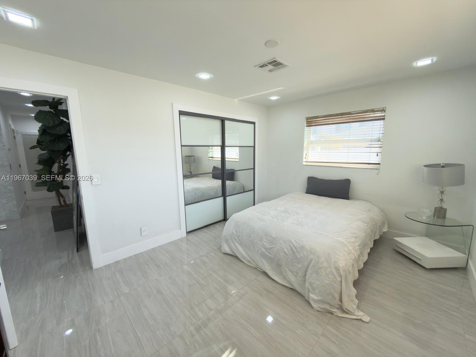 4801 West Park Road Hollywood, FL 33021 - Photo 16 of 30 a bedroom with a bed and a walk in closet