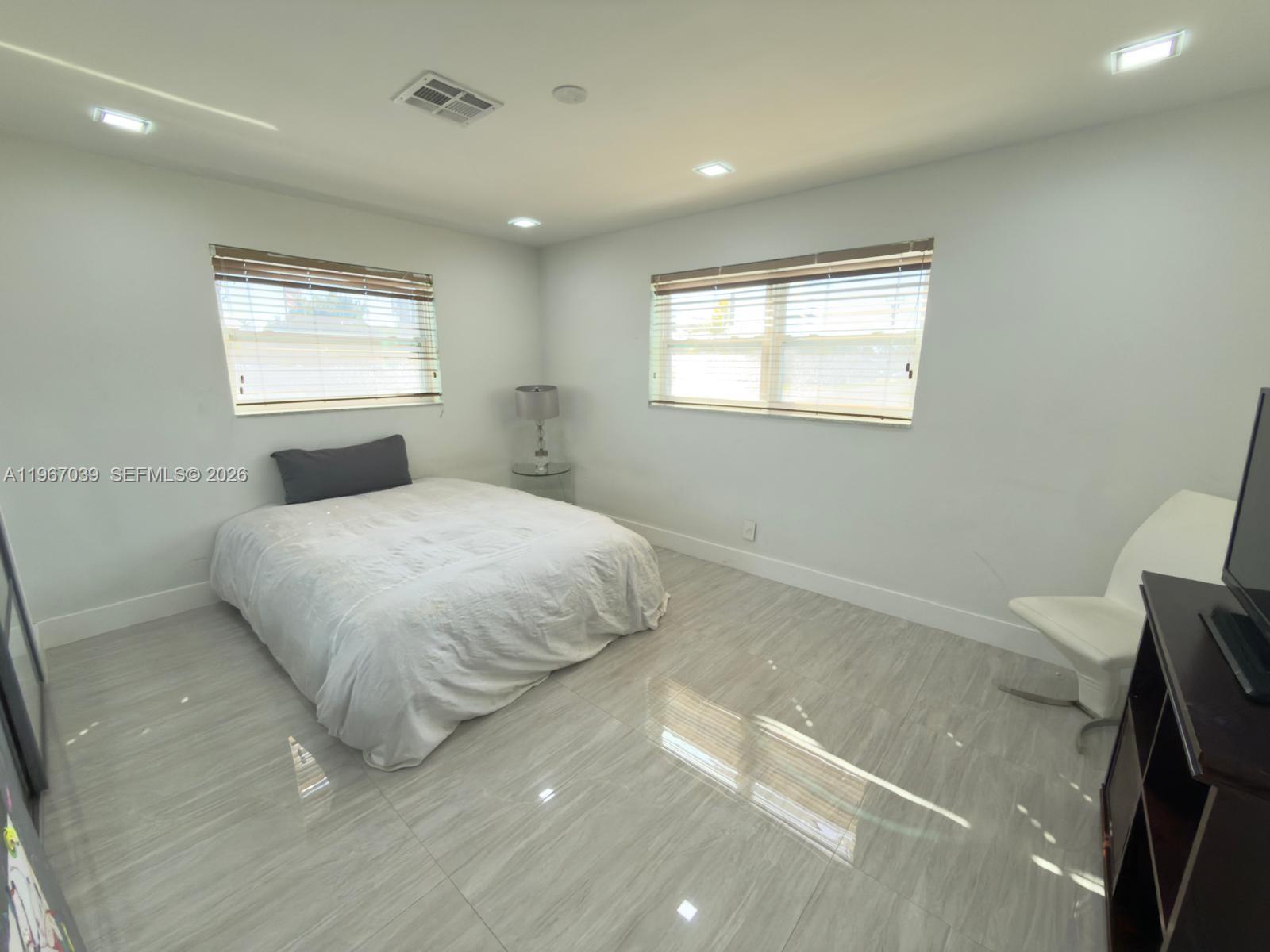 4801 West Park Road Hollywood, FL 33021 - Photo 17 of 30 a bedroom with a bed and a window