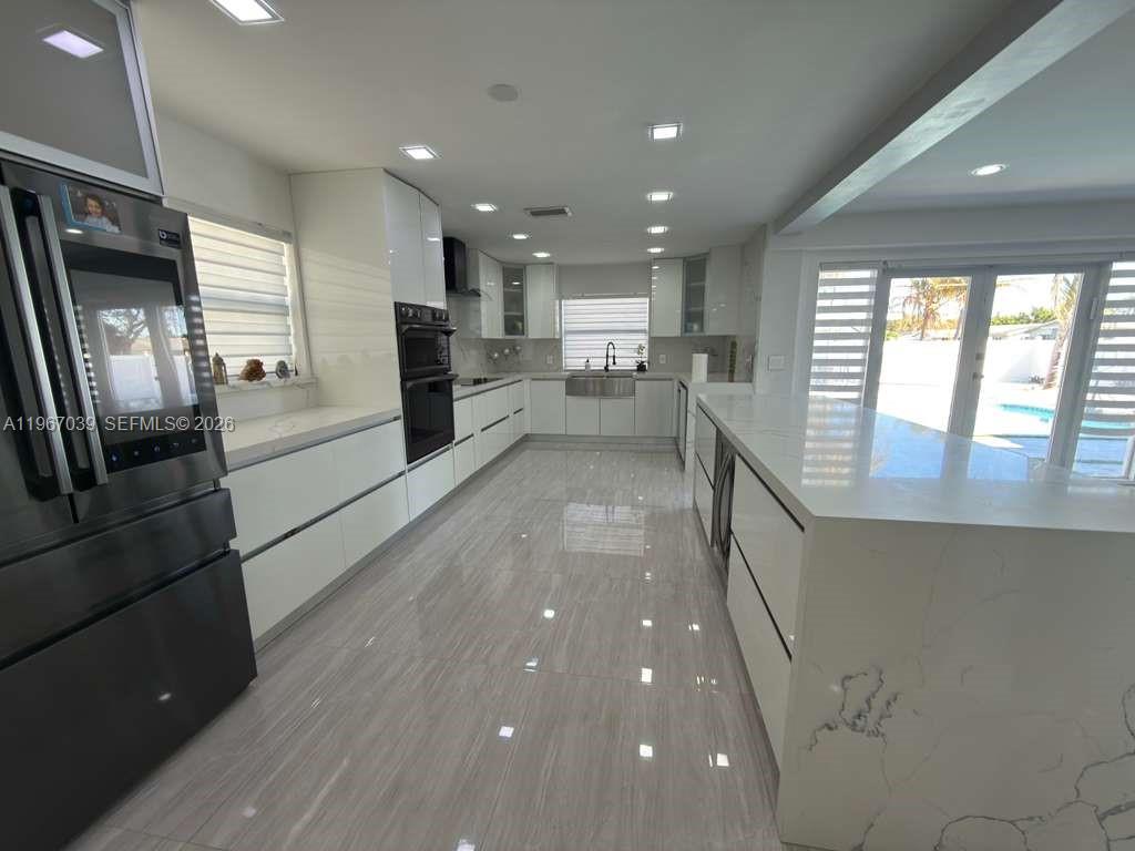 4801 West Park Road Hollywood, FL 33021 - Photo 2 of 30 a view of a kitchen with a sink and refrigerator