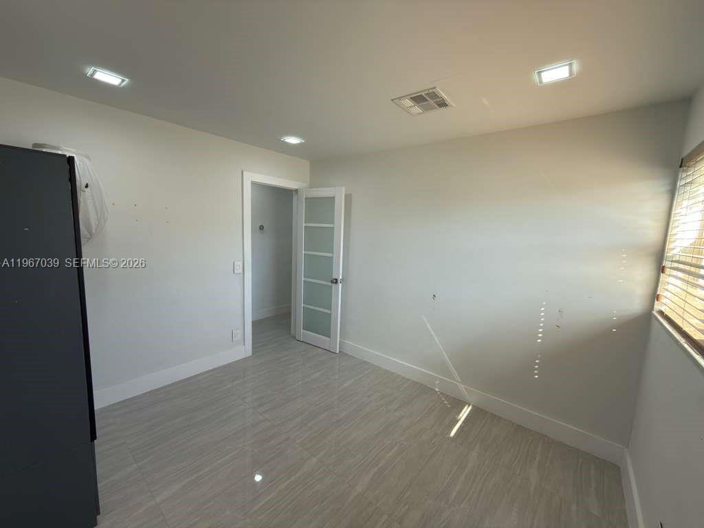 4801 West Park Road Hollywood, FL 33021 - Photo 21 of 30 an empty room with wooden floor and closet