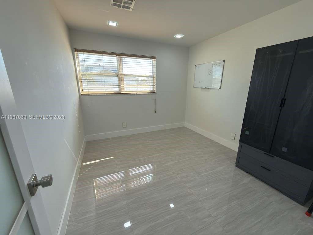 4801 West Park Road Hollywood, FL 33021 - Photo 22 of 30 a view of empty room with wooden floor and fan