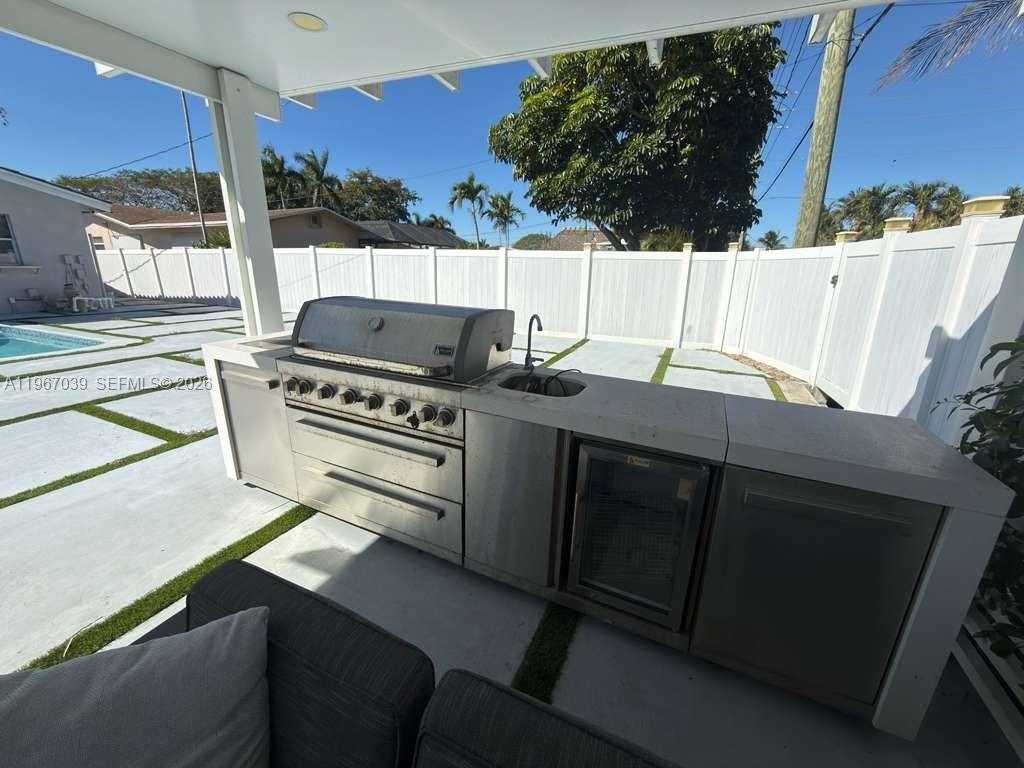 4801 West Park Road Hollywood, FL 33021 - Photo 24 of 30 a kitchen with a stove and a refrigerator