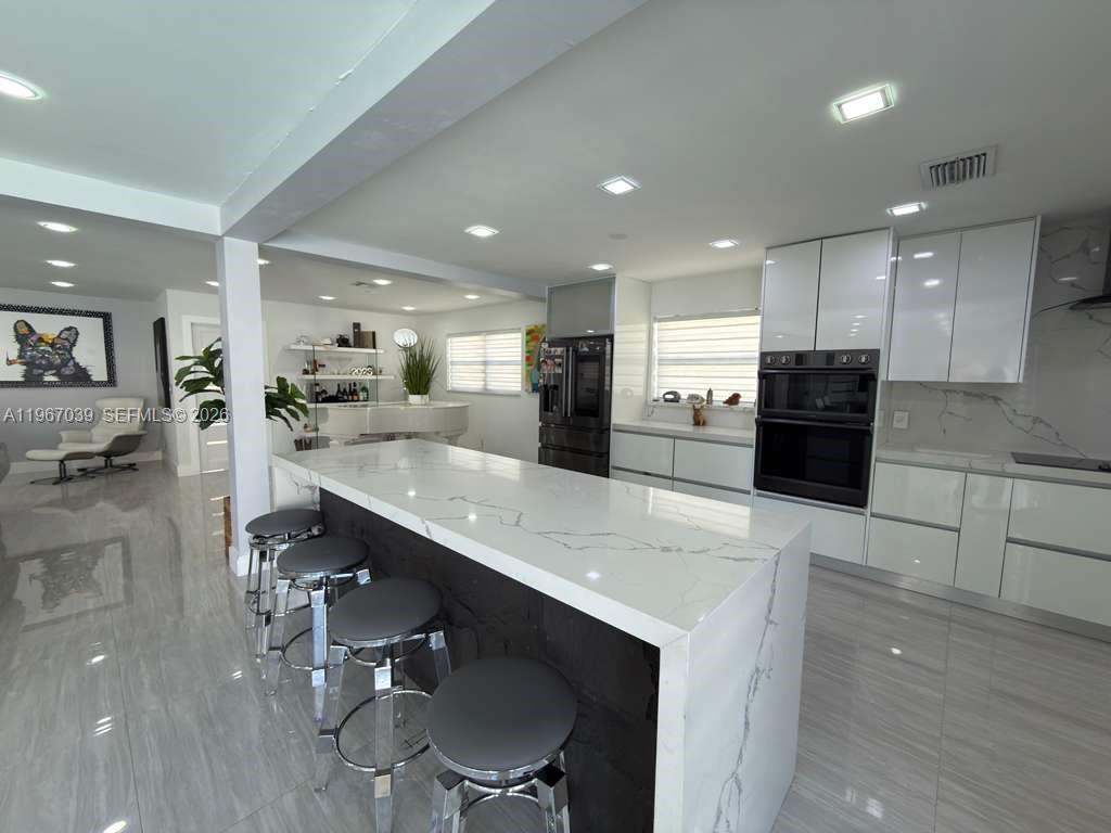 4801 West Park Road Hollywood, FL 33021 - Photo 3 of 30 a large kitchen with a table and chairs