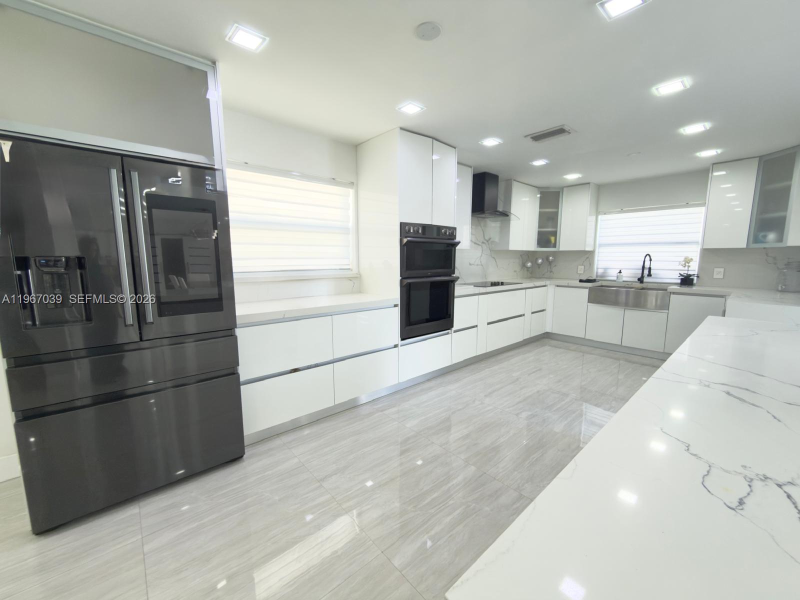 4801 West Park Road Hollywood, FL 33021 - Photo 4 of 30 a kitchen with stainless steel appliances kitchen island granite countertop a refrigerator and a sink