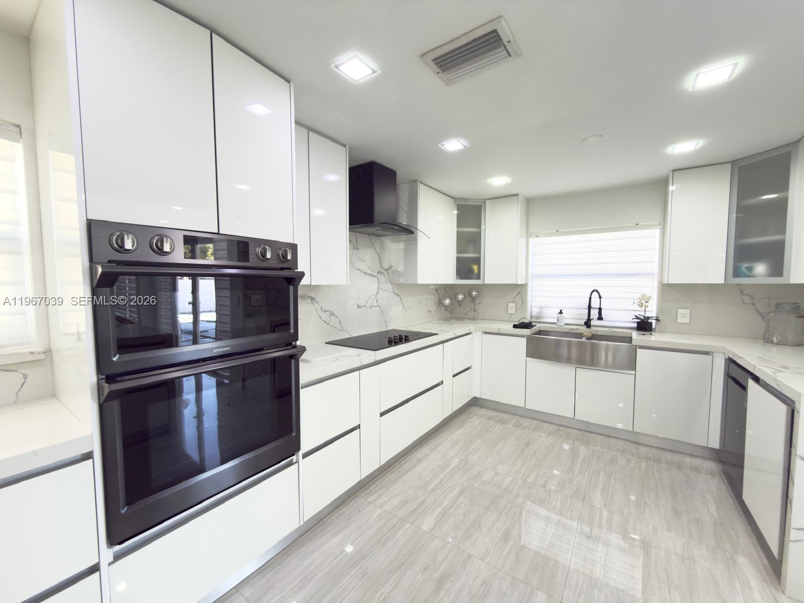 4801 West Park Road Hollywood, FL 33021 - Photo 5 of 30 a large kitchen with stainless steel appliances granite countertop a stove and a sink