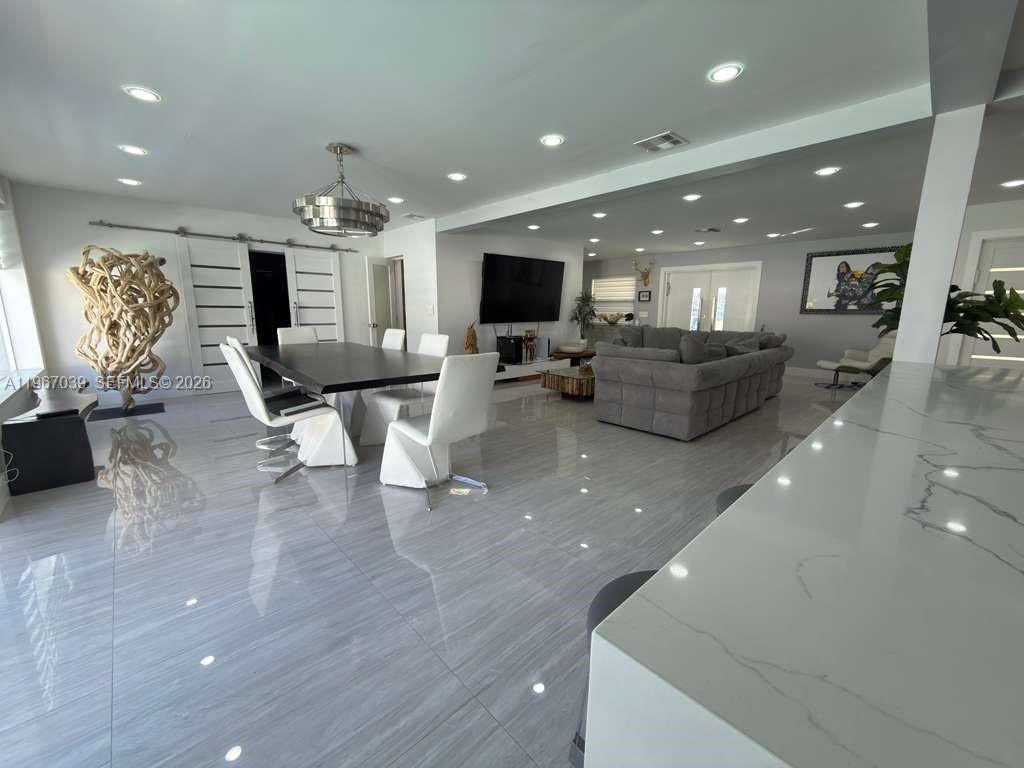 4801 West Park Road Hollywood, FL 33021 - Photo 6 of 30 a living room with furniture and a flat screen tv